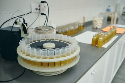 High angle of plastic tubes with samples of various liquids placed on table in modern laboratory