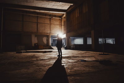 Full length of silhouette man standing in basement