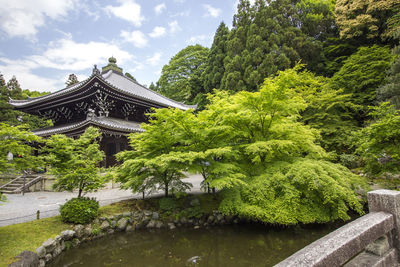 Temple by building against sky