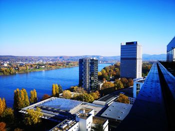 High angle view of city buildings against clear blue sky