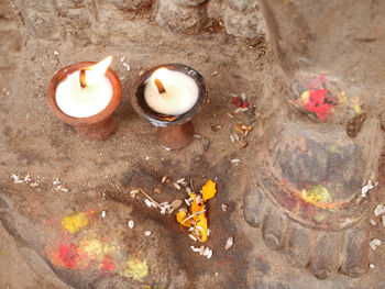 High angle view of lit candles on wall