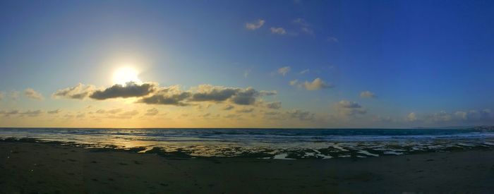 Scenic view of beach against sky during sunset