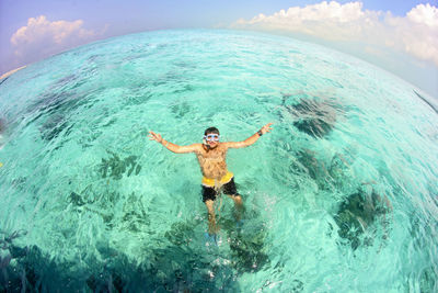 High angle view of man swimming in sea against sky