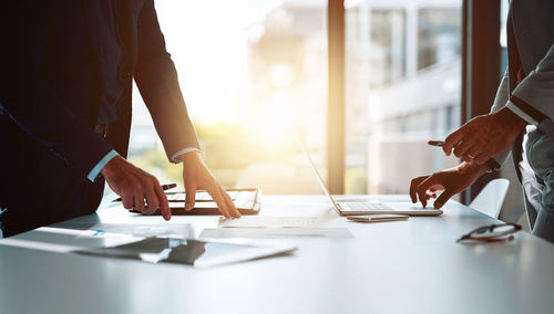 Midsection of business colleagues working at office