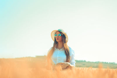 Woman standing on agricultural field