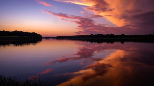 Scenic view of lake against romantic sky at sunset