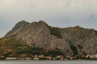 Scenic view of sea and mountains against sky