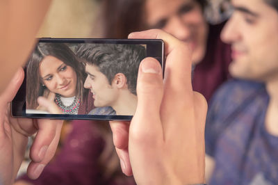Portrait of woman photographing with mobile phone