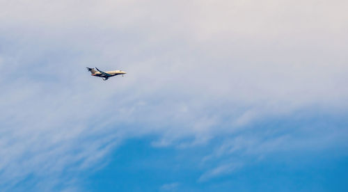 Low angle view of airplane flying in sky