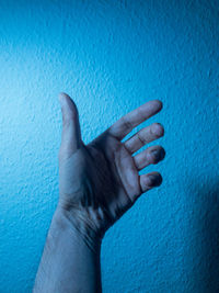 Cropped hand of person against wall