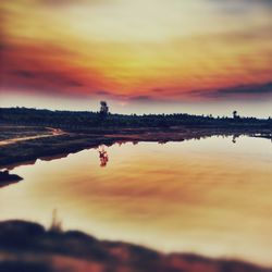 Scenic view of lake against dramatic sky