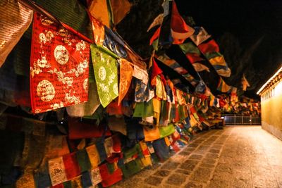 Low angle view of flags hanging at night