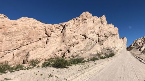 Road amidst rocks against clear sky