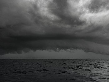 Scenic view of sea against storm clouds