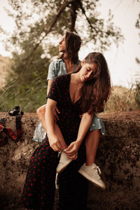 Lesbian couple sitting on land