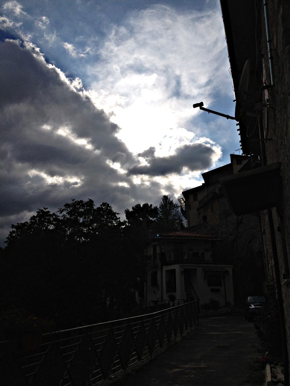 sky, building exterior, built structure, architecture, cloud - sky, tree, house, cloudy, cloud, silhouette, residential structure, low angle view, the way forward, residential building, outdoors, street light, street, building, day, sunlight