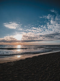 Scenic view of beach against sky during sunset
