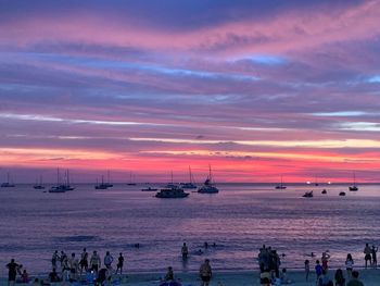 View of boats in sea at sunset