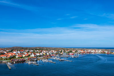 High angle view of townscape by sea against sky