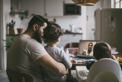 Man and woman sitting at home