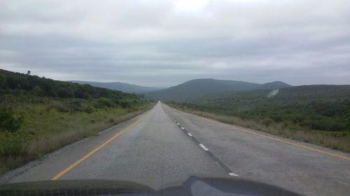 Empty road passing through landscape