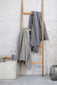 Towel hanging on ladder by wall