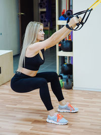 Full length of woman exercising in gym