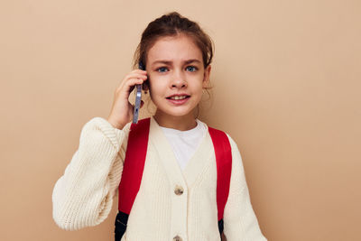 Portrait of smiling girl talking on phone