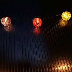 Low angle view of illuminated lanterns hanging on ceiling