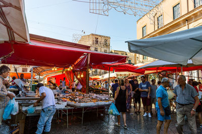 People at market stall in city