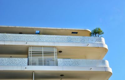 Low angle view of building against clear blue sky
