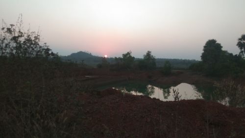 Scenic view of field against sky during sunset