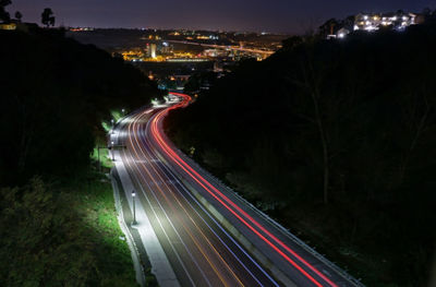 High angle view of light trails on road at night