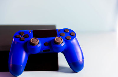 Close-up of blue toy on table against white background