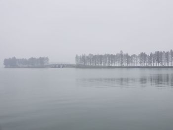 Scenic view of lake against sky during winter