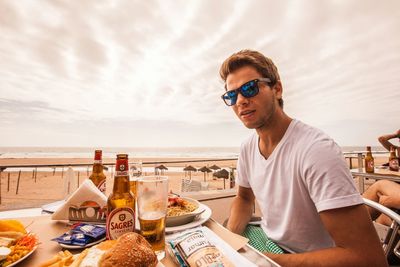 Young couple sitting on table at beach