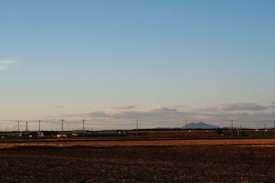 Scenic view of agricultural field against sky during sunset