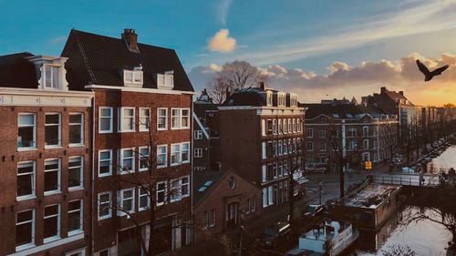 Buildings in city during sunset