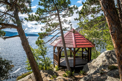 Lifeguard hut on land against trees