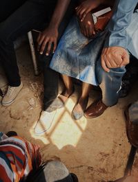 Low section of people sitting on floor