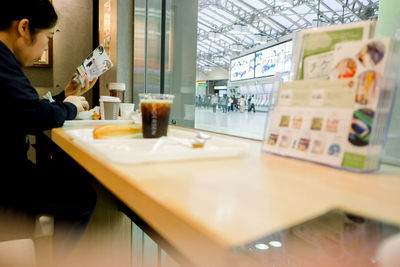 Midsection of man having food in restaurant