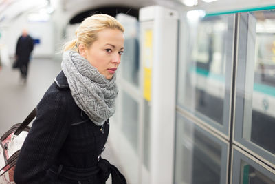 Beautiful woman standing on railroad station platform