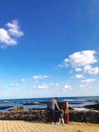 Man looking at sea against sky