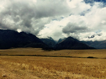 Scenic view of mountains against cloudy sky