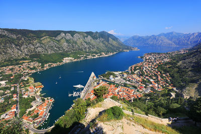 High angle view of kotor town by sea amidst mountains