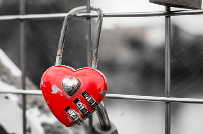 Close-up of love padlocks hanging on railing