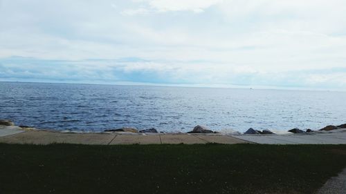 Scenic view of sea against cloudy sky