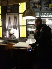 Side view of man using smart phone