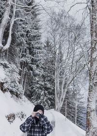 Man in snow covered trees