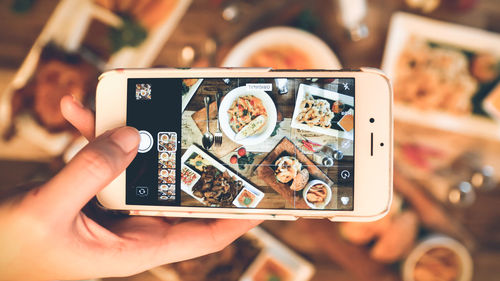 Close-up of person photographing with mobile phone